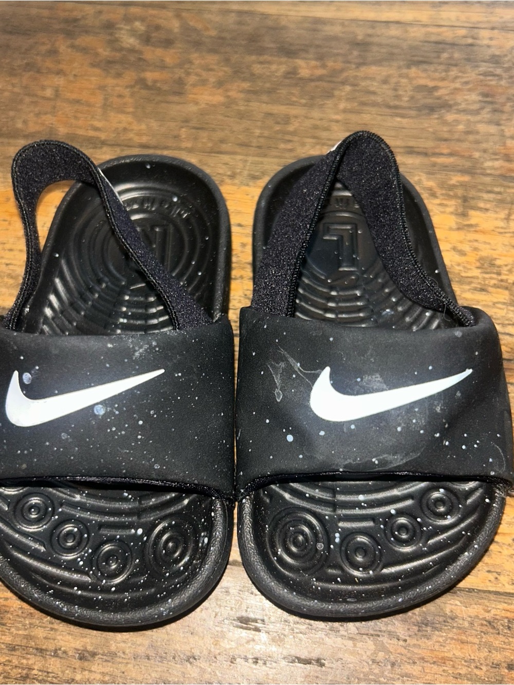 Nike Black Kids' Slide Sandals with White Swoosh and Paint-Splatter Detail